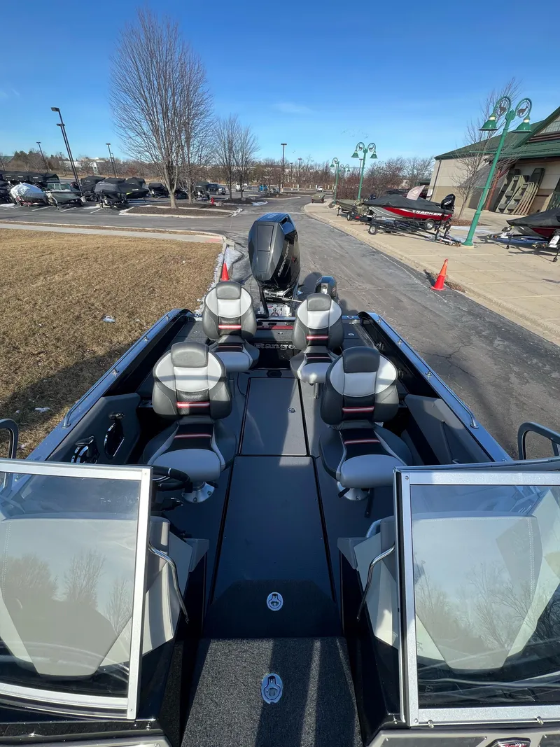 Slide: The Image of 2024 Ranger 622FS Pro boat with seating and motor, parked outdoors on a sunny day. - 8