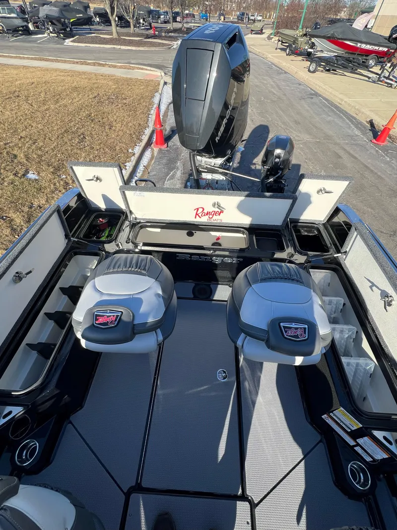 Slide: The Image of 2024 Ranger 622FS Pro boat interior with dual seats and powerful outboard motor. - 9