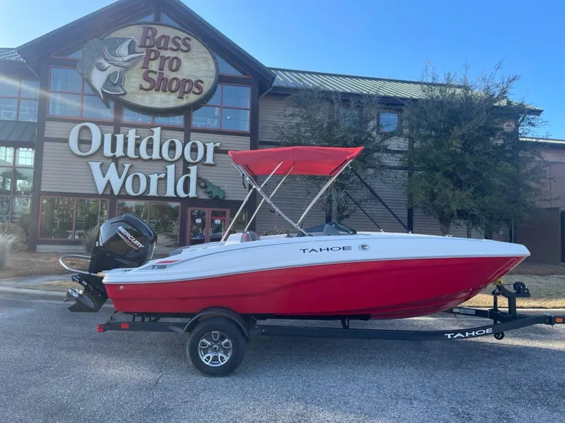 Slide: The Image of 2025 Tahoe T18 boat with red canopy outside Bass Pro Shops Outdoor World. - 0