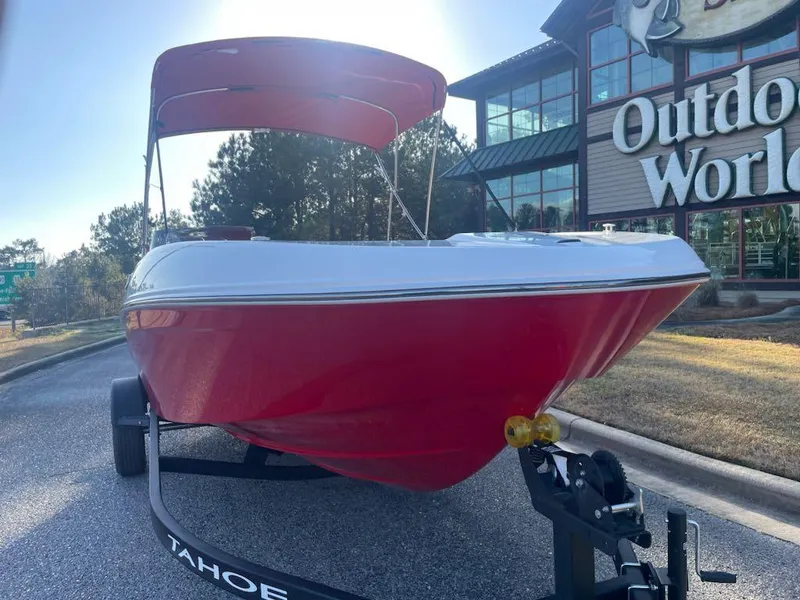 Slide: The Image of 2025 Tahoe T18 boat with red hull and canopy at Outdoor World. - 2