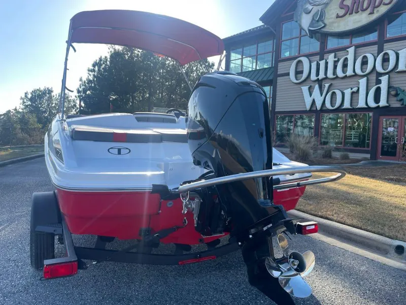 Slide: The Image of 2025 Tahoe T18 boat with outboard motor parked near Outdoor World store. - 3