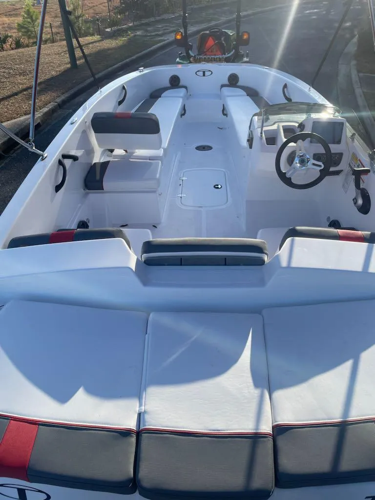 Slide: The Image of 2025 Tahoe T18 boat interior with seating and steering wheel, showcasing modern design. - 4