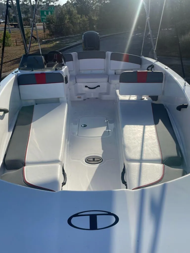 Slide: The Image of 2025 Tahoe T18 boat interior with seating and storage, under sunlight. - 5