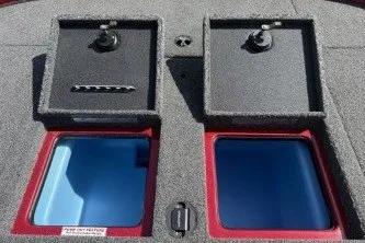 Slide: The Image of 2025 Nitro Z19 boat storage compartments with open lids and red trim. - 8