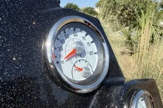 Slide: The Image of Close-up of Nitro Z19 2025 speedometer with red needle, outdoors. - 6