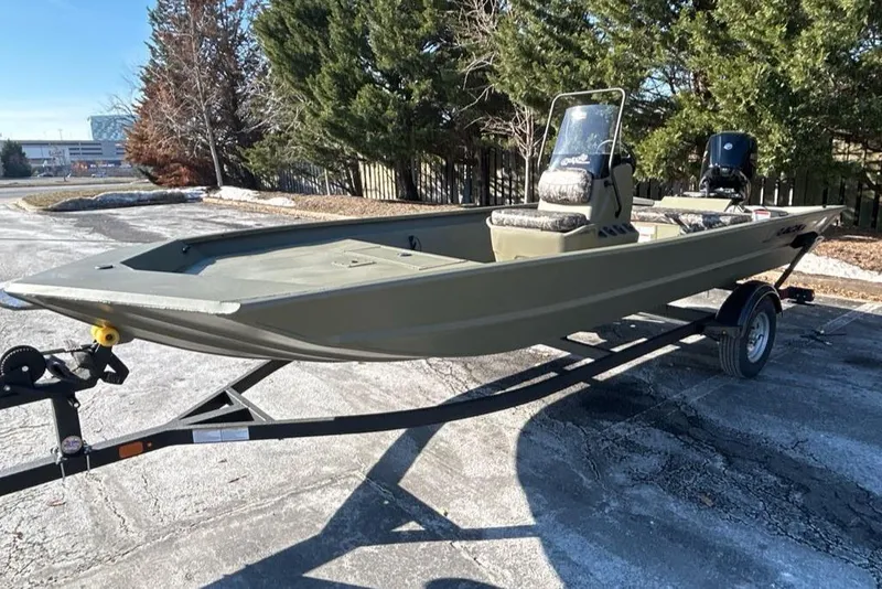 Slide: The Image of 2025 Tracker Grizzly 1860 CC boat on trailer, parked outdoors. - 2