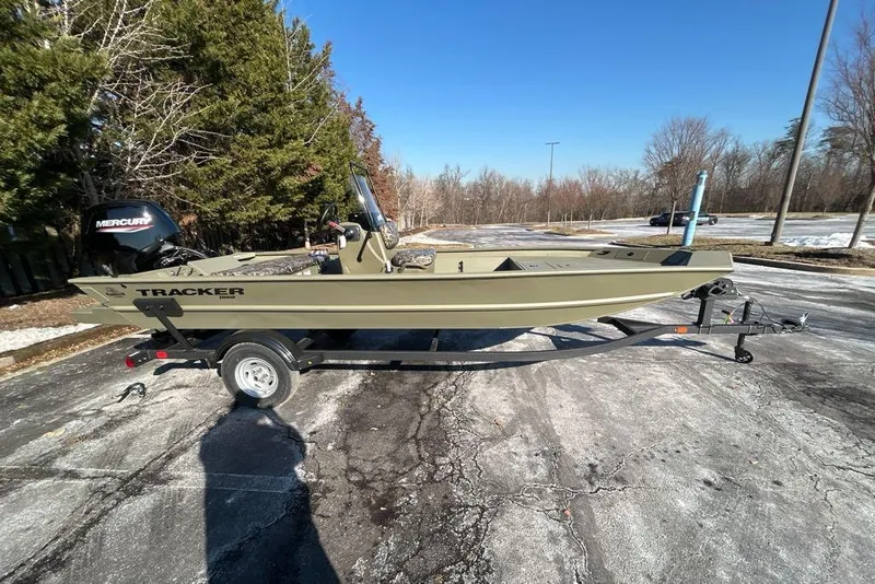 Slide: The Image of 2025 Tracker Grizzly 1860 CC boat on trailer, parked outdoors on a sunny day. - 3