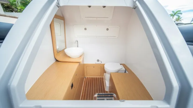 Slide: The Image of Interior of 2025 Skipper 38 NC boat, featuring modern bathroom with wooden accents. - 21