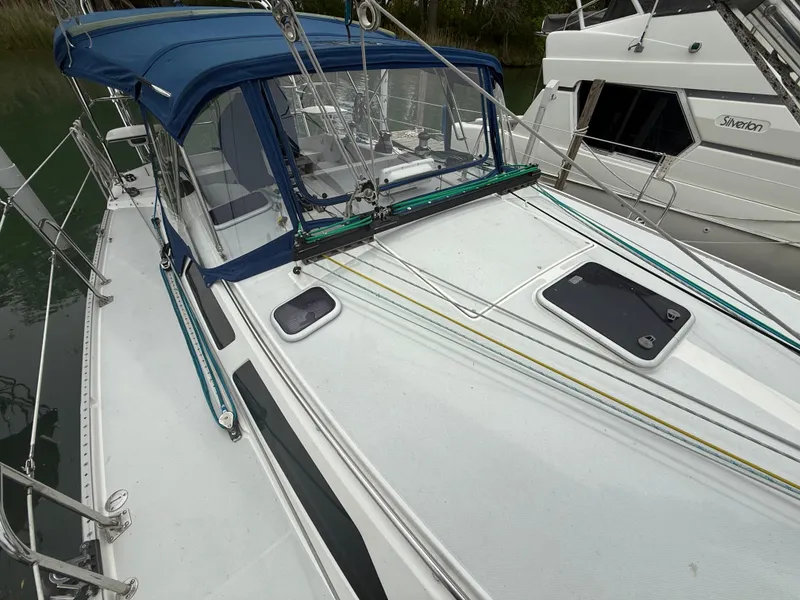 Slide: The Image of 2001 Catalina 42 MkII sailboat with blue canopy and deck details. - 10