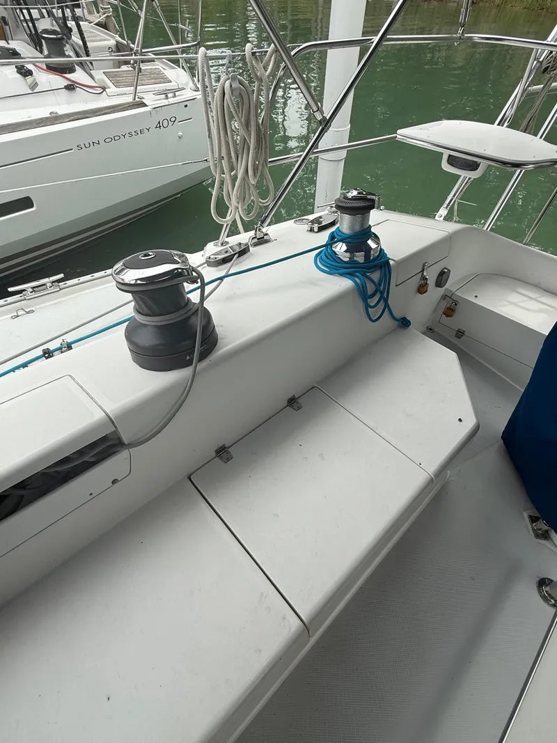 Slide: The Image of 2001 Catalina 42 MkII sailboat deck with winches and ropes, docked near water. - 18