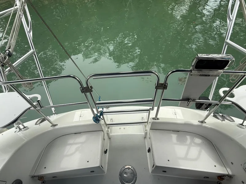 Slide: The Image of Stern view of 2001 Catalina 42 MkII sailboat with railing and calm water. - 19