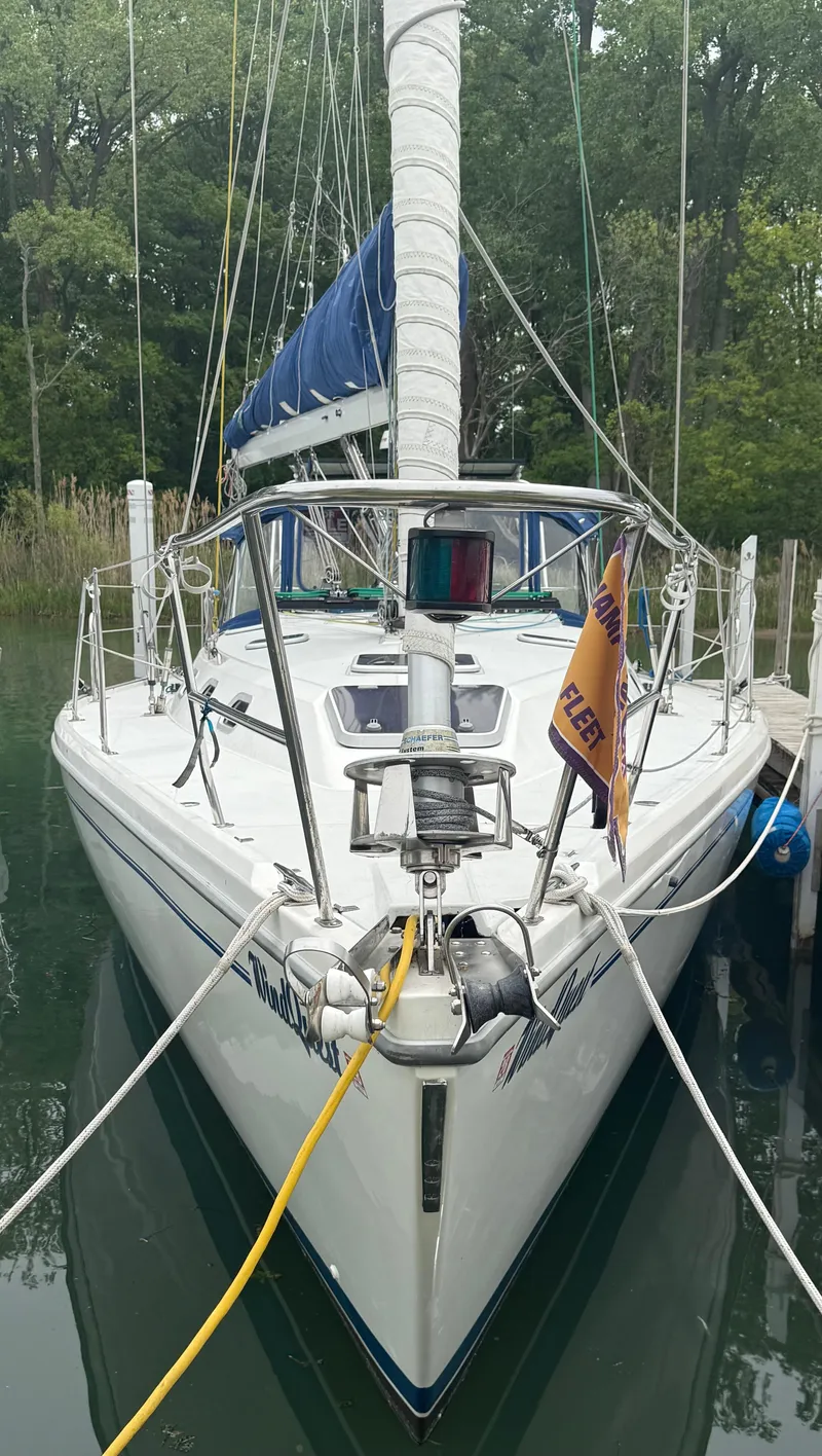 Slide: The Image of Front view of a 2001 Catalina 42 MkII sailboat docked in a marina. - 2