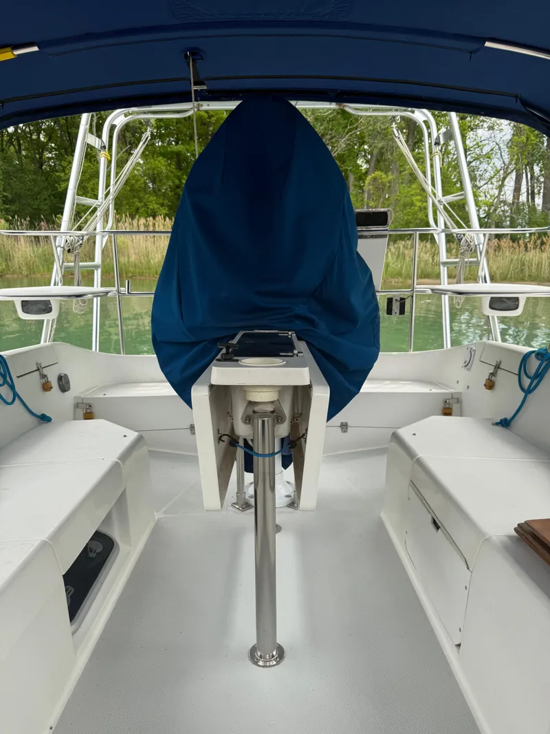 Slide: The Image of 2001 Catalina 42 MkII sailboat cockpit with covered helm, white seating, and blue canopy. - 24