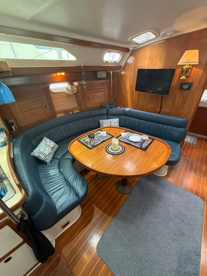 Slide: The Image of Interior of 2001 Catalina 42 MkII sailboat with cozy seating and wooden table. - 25