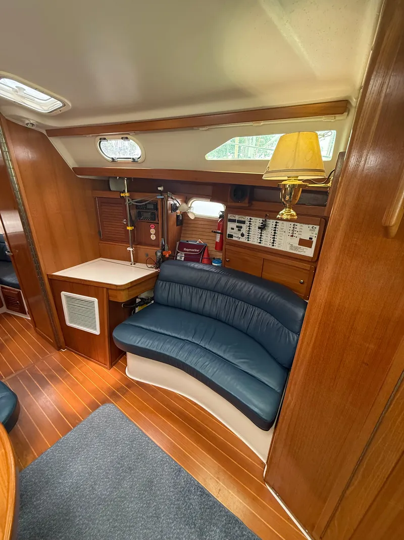 Slide: The Image of Interior of 2001 Catalina 42 MkII sailboat with blue seating and wooden finishes. - 28