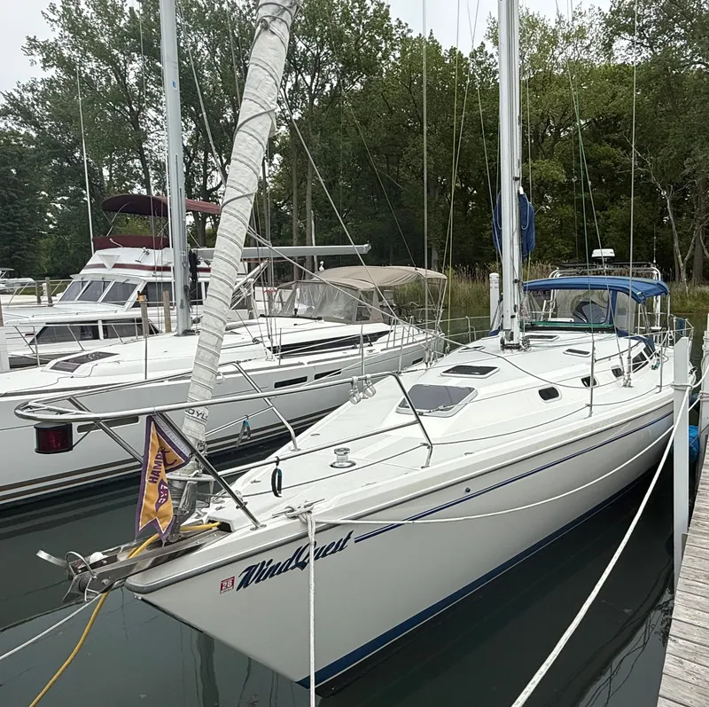Slide: The Image of 2001 Catalina 42 MkII sailboat docked in a marina, surrounded by trees. - 3