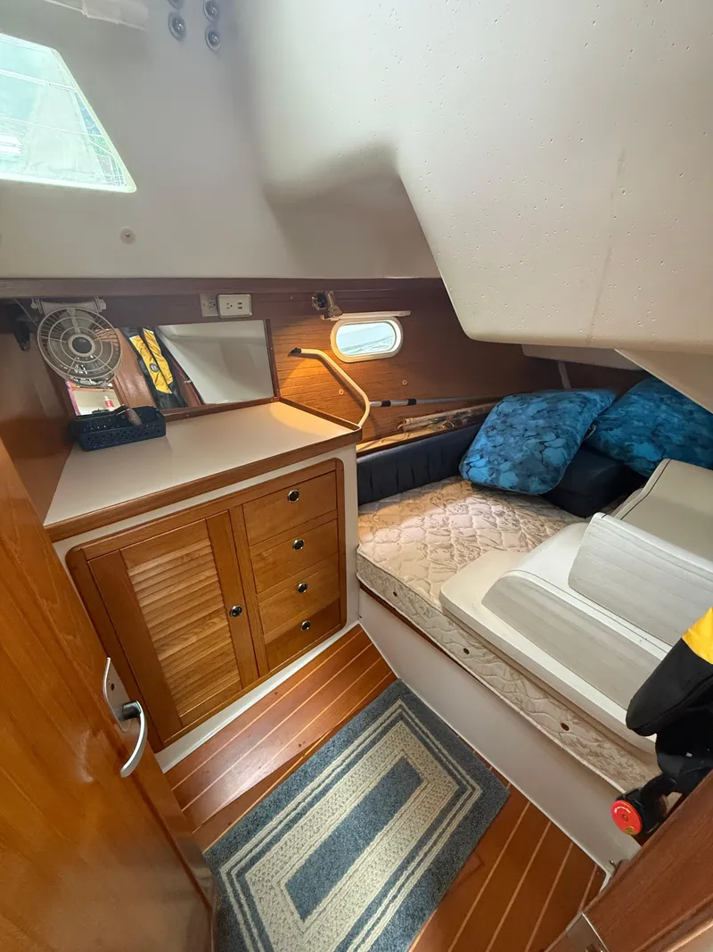 Slide: The Image of 2001 Catalina 42 MkII cabin interior with bed, storage, and window. - 31