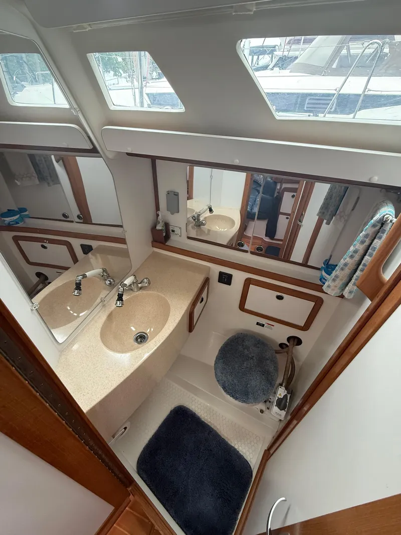 Slide: The Image of Bathroom interior of a 2001 Catalina 42 MkII sailboat with sink and mirror. - 32