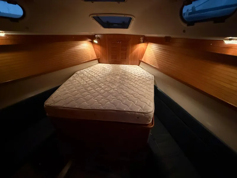 Slide: The Image of Cozy cabin interior of 2001 Catalina 42 MkII sailboat with mattress and warm lighting. - 36