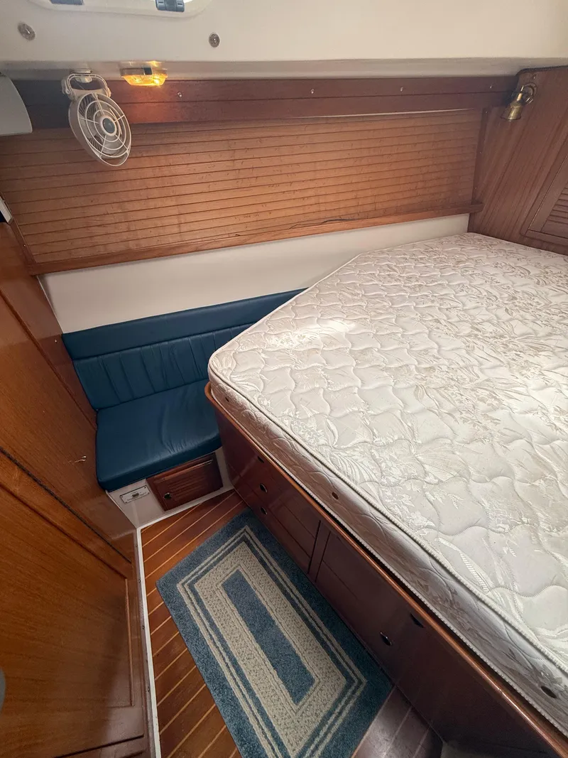 Slide: The Image of 2001 Catalina 42 MkII cabin interior with bed, blue seating, and wooden accents. - 37