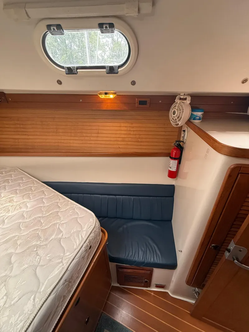 Slide: The Image of Interior of 2001 Catalina 42 MkII sailboat cabin with bed, seating, and porthole. - 38