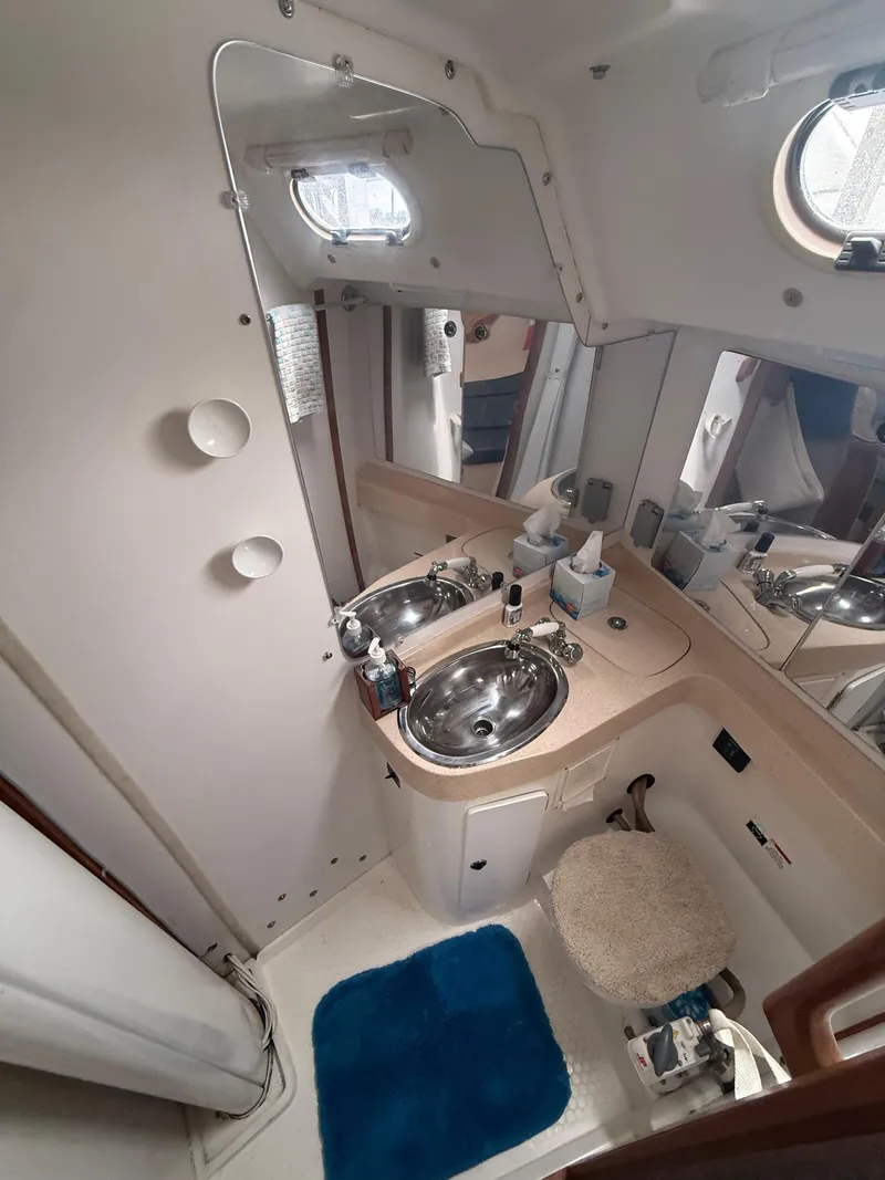 Slide: The Image of 2001 Catalina 42 MkII yacht bathroom with sink, mirror, and porthole. - 39