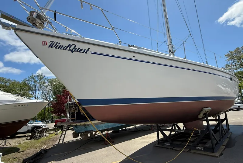 Slide: The Image of Catalina 42 MkII sailboat from 2001, named "WindQuest," on a stand under a clear sky. - 41
