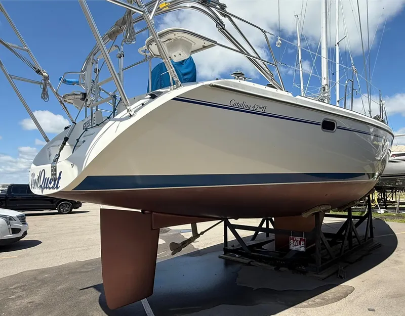 Slide: The Image of 2001 Catalina 42 MkII sailboat on display, elevated on a stand, with a "For Sale" sign. - 47