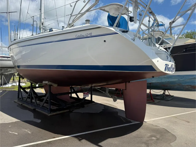 Slide: The Image of 2001 Catalina 42 MkII sailboat on dry dock, showcasing hull and keel. - 48