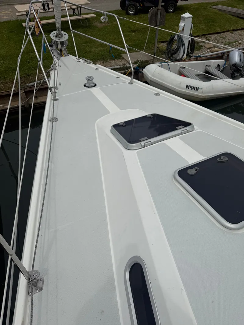 Slide: The Image of 2001 Catalina 42 MkII sailboat deck with hatches, docked near inflatable dinghy. - 5