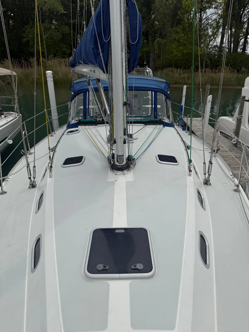 Slide: The Image of 2001 Catalina 42 MkII sailboat deck with blue sail cover, docked in a marina. - 6