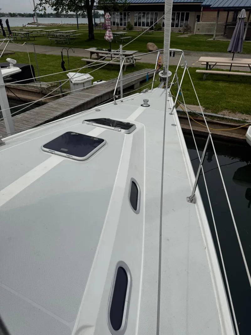 Slide: The Image of 2001 Catalina 42 MkII sailboat docked, showcasing sleek deck design and mooring area. - 7