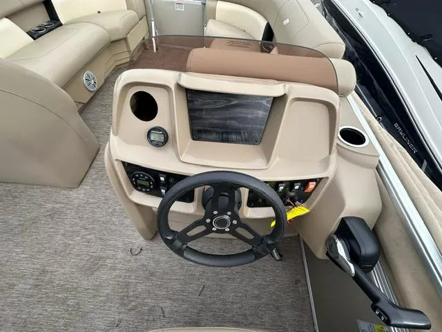 Slide: The Image of 2021 Starcraft LX 22 R boat dashboard with steering wheel and control panel. - 4