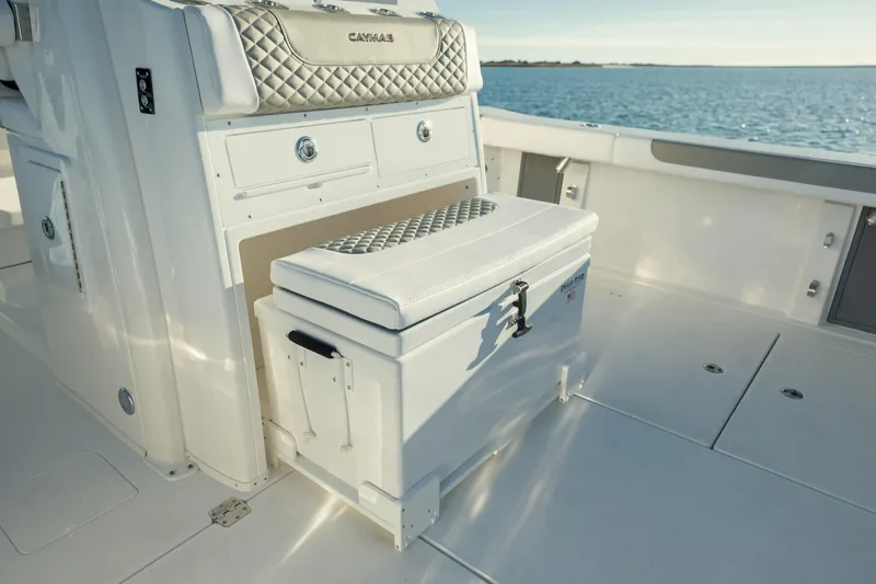 Slide: The Image of 2025 Caymas 34 CT boat interior with storage and seating, overlooking the ocean. - 12