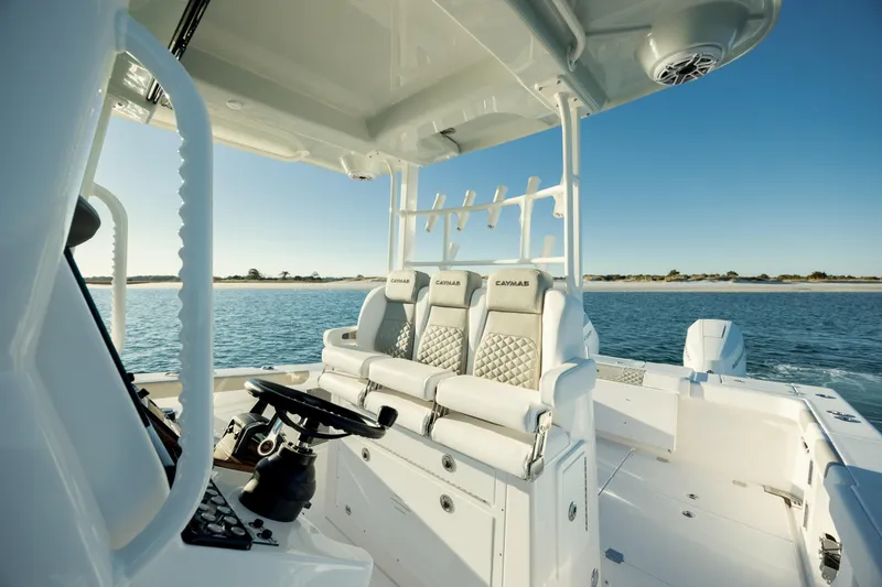 Slide: The Image of 2025 Caymas 34 CT boat interior with luxurious seating on calm water. - 15