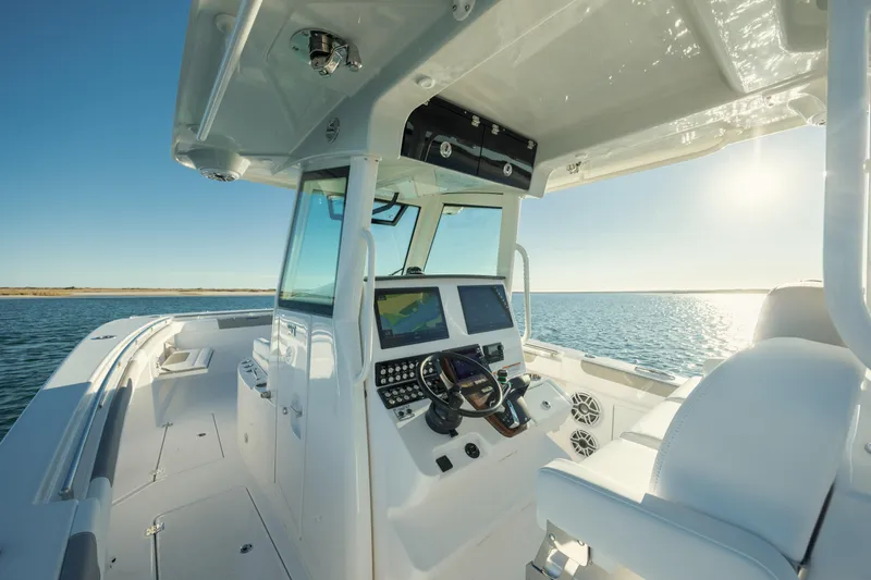 Slide: The Image of 2025 Caymas 34 CT boat interior with modern dashboard on open water. - 16