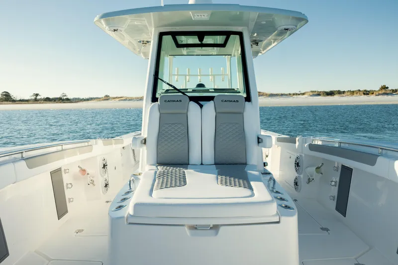 Slide: The Image of 2025 Caymas 34 CT boat interior with seating, on calm water. - 21