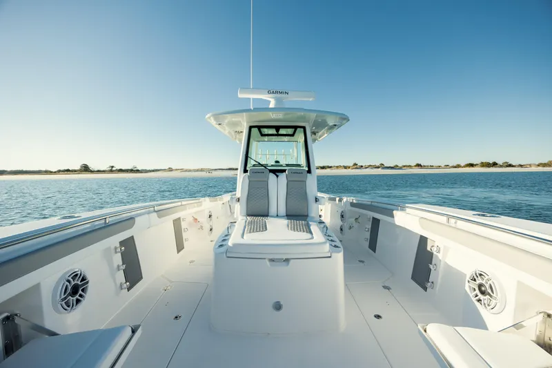 Slide: The Image of 2025 Caymas 34 CT boat on calm water, showcasing spacious deck and modern design. - 23
