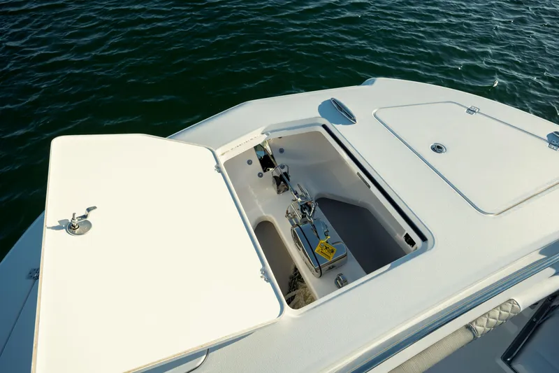 Slide: The Image of 2025 Caymas 34 CT boat anchor compartment open on calm water. - 26