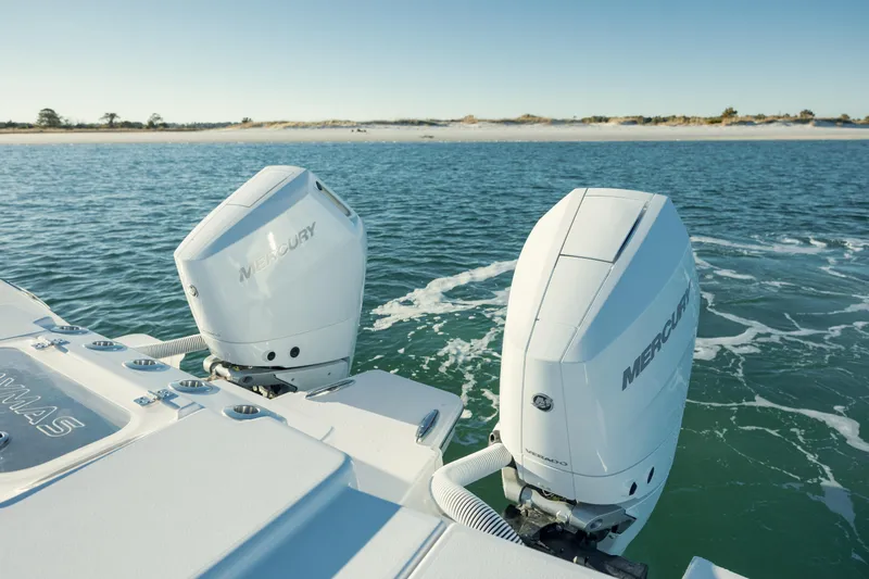 Slide: The Image of 2025 Caymas 34 CT boat with dual Mercury outboard engines on open water. - 7