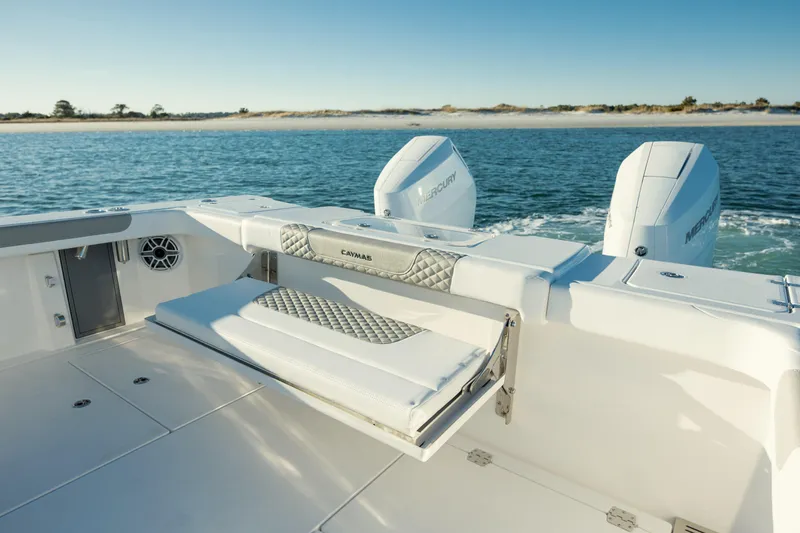 Slide: The Image of 2025 Caymas 34 CT boat with dual engines on a serene water backdrop. - 8