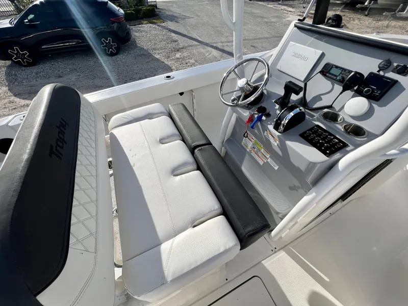 Slide: The Image of 2023 Bayliner Trophy 24 CC boat interior with steering console and seating. - 15