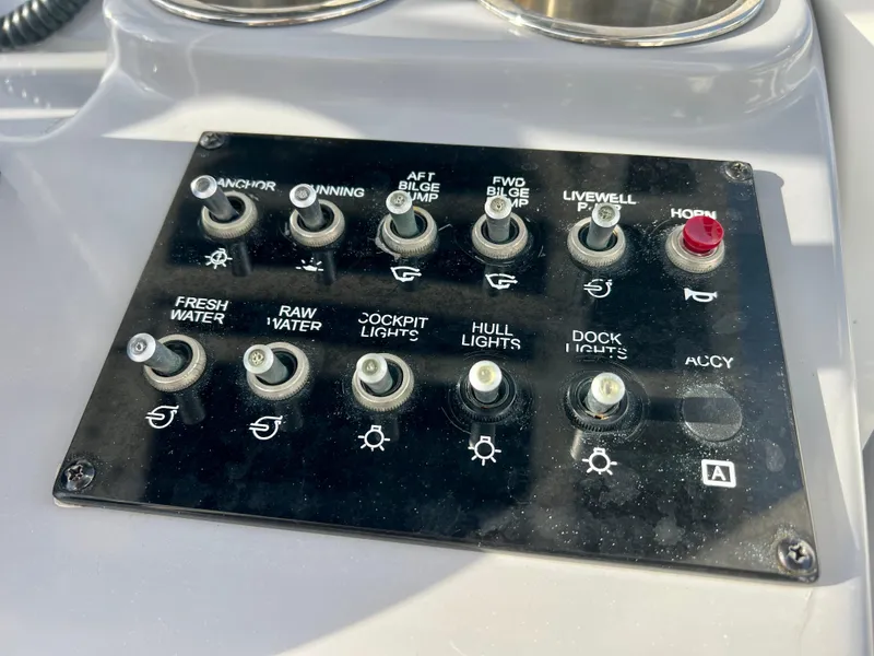 Slide: The Image of Control panel of 2023 Bayliner Trophy 24 CC boat with various switches. - 18