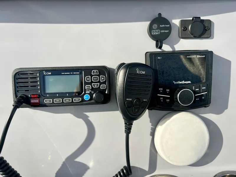 Slide: The Image of Control panel of 2023 Bayliner Trophy 24 CC with Icom radio and Rockford Fosgate system. - 19