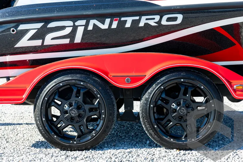 Slide: The Image of 2017 Nitro Z21 Z-PRO Package boat trailer with black wheels and red fenders. - 13