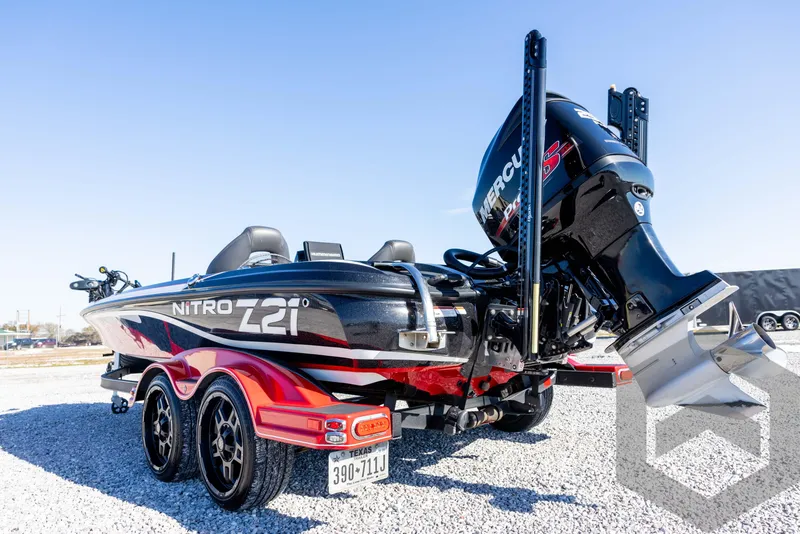 Slide: The Image of 2017 Nitro Z21 Z-PRO Package boat with Mercury engine, parked on gravel. - 21