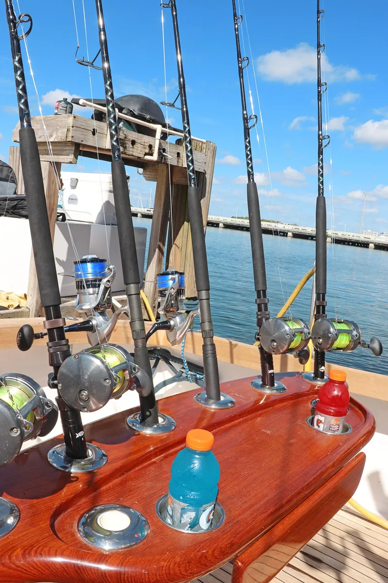 Slide: The Image of Fishing rods on a 1997 Gamefisherman 34 Express boat, docked by the water. - 12