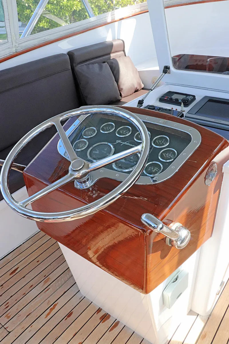 Slide: The Image of Helm of 1997 Gamefisherman 34 Express with wooden dashboard and steering wheel. - 13