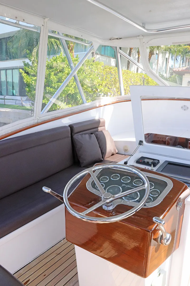 Slide: The Image of 1997 Gamefisherman 34 Express boat interior with steering wheel and seating area. - 15