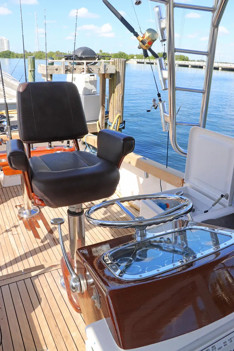 Slide: The Image of Gamefisherman 34 Express 1997 boat interior with fishing chair and rod holder. - 16